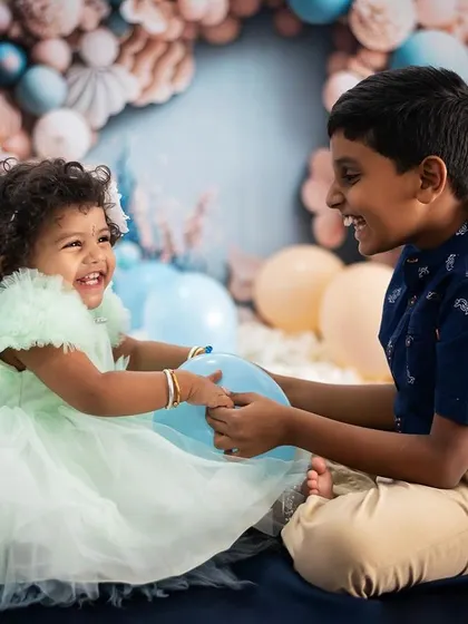 Pure joy and laughter between siblings. This candid moment captures the fun and playful side of their relationship, a memory they'll love looking back on.