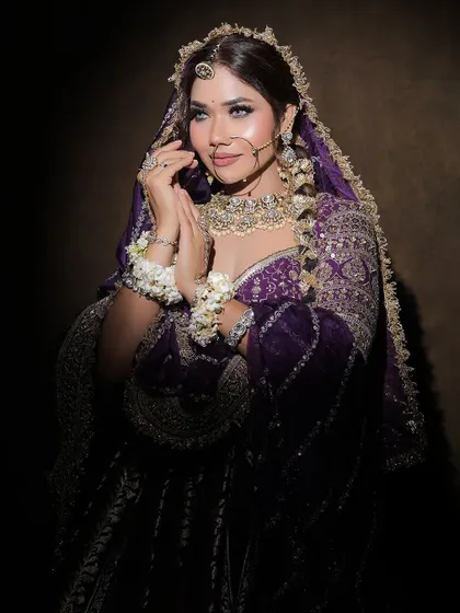 A full shot of the purple lehenga, highlighting the rich color and the traditional yet glamorous feel of the entire look.