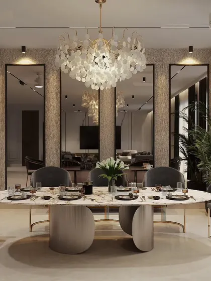 An elegant dining space designed for memorable gatherings. We used a stunning shell-petal chandelier as the centerpiece, complemented by a marble-topped oval table and velvet-upholstered chairs with brass accents for a touch of opulence.