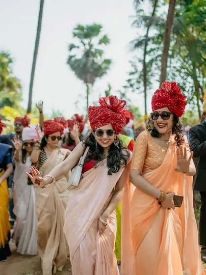The energy of the baraat is infectious. Here, guests are seen dancing and celebrating the groom's arrival.