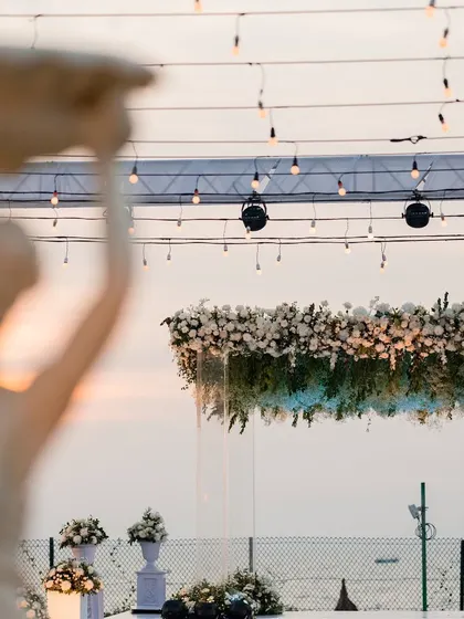A detail shot of the floating floral mandap against the ocean sunset, a testament to dreamy destination wedding decor.