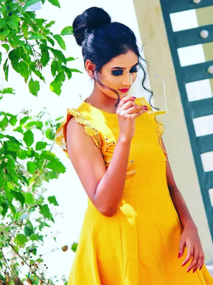 This look is all about sharp, defined features for the camera. I created a strong winged eyeliner and a high top knot bun, paired with a bright yellow dress for a stylish and modern photoshoot.