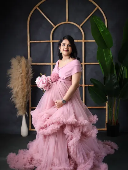 A lovely portrait in a pink gown, set against our dark arched window prop. The contrast creates a moody yet romantic atmosphere.