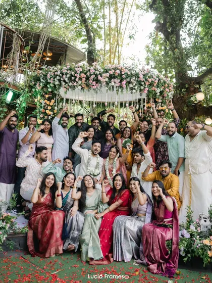 A huge, happy group photo with all the family and friends, celebrating the couple's union.