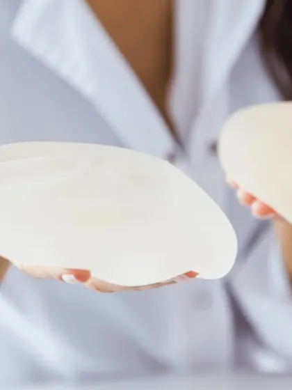 Choosing the right breast implant is a critical step. In this image, you can see two different implant profiles. We will discuss options like silicone or saline, and round or teardrop shapes during your consultation.