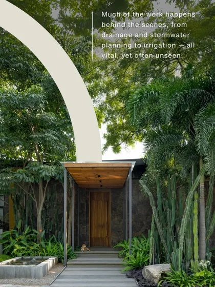 A view of a beautifully designed entrance, with text explaining the unseen work of drainage and stormwater planning. This educates the client on the technical aspects of landscape architecture.