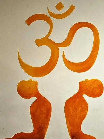 The sacred symbol 'Om' painted on the wall of a yoga shala, representing the universal sound and consciousness.