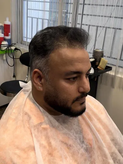 The "before" shot, showing the client's natural dark hair prior to the silver transformation.