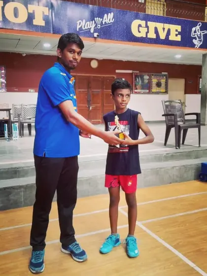 A young player receiving his trophy. I ensure that every student's hard work is recognized.