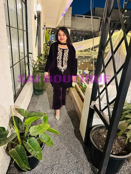 A client wearing a beautiful wine-colored velvet suit with gold embroidery. This is a luxurious and warm option for a winter evening event.