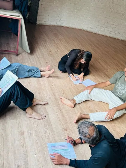 Our process often includes moments of quiet reflection and creative ideation. Here, participants are taking time to write and process their experiences on the floor, integrating the physical work with personal insights.