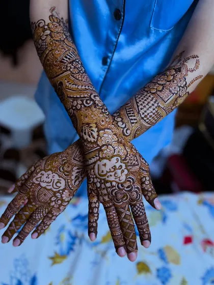 A crossed-hands pose showing the beautiful symmetry and personalized details of this unique bridal design.