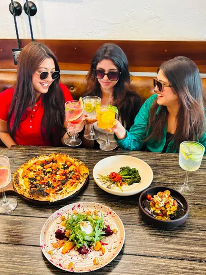 Another shot of the girls enjoying their time. The smiles say it all. Good food brings people together.