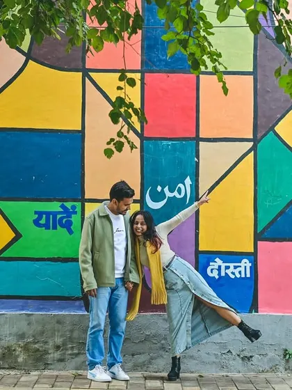 We love incorporating vibrant, modern backdrops into our pre-wedding shoots. This colorful mural adds a playful and artistic energy to the couple's portraits, showing their fun side.
