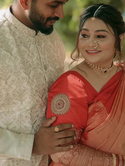 A close-up shot focusing on the bride's loving gaze and the intricate embroidery on the groom's sherwani.
