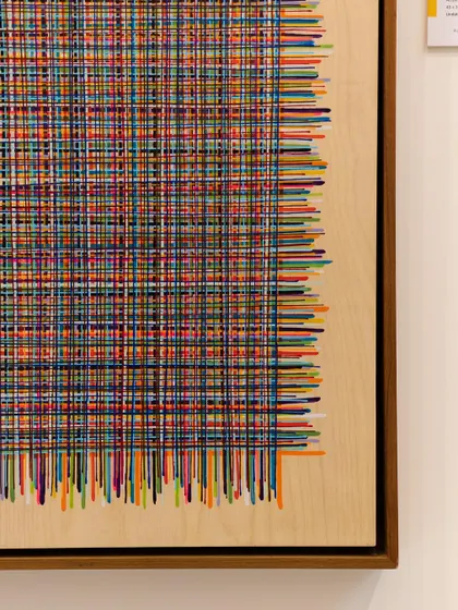 This intricate work by Harisha Chennangod is a meditative exploration of repetition and balance. Each line is meticulously placed, forming a rhythmic composition of woven colors that feels both structured and organic.