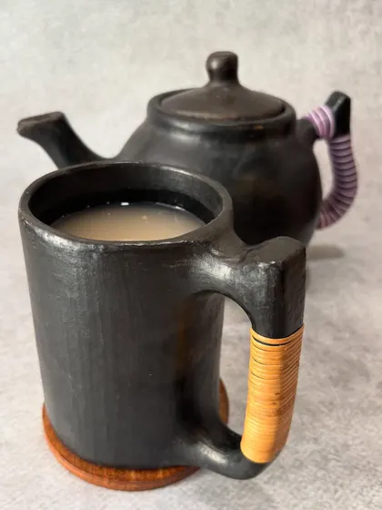 Our traditional Naga rice drink, Zutho, served in a handcrafted Longpi pottery mug and pot. This ancient pottery from Manipur adds a touch of heritage to the experience.
