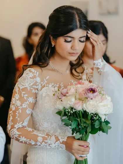 A candid moment during the ceremony. Her makeup looks flawless and natural, allowing her emotions to be the focus.