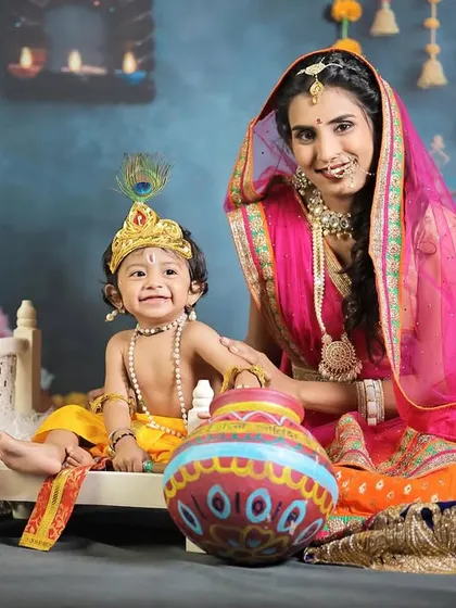 A smiling portrait of "Yashoda" and "Krishna," capturing the joy of their mythological-themed session.