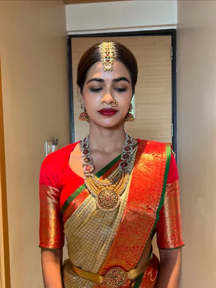 A serene bridal portrait, capturing the elegance of the complete muhurtham look, from the maang tikka to the perfectly draped saree.
