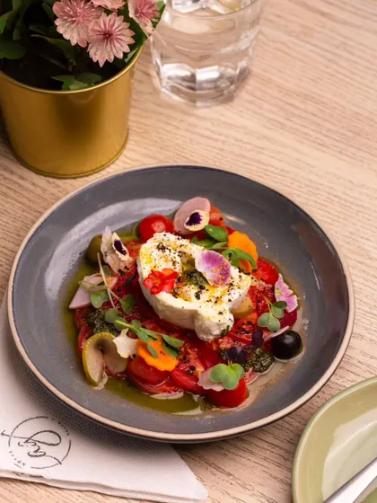 Simplicity at its finest. My Tomato and Burrata salad showcases the beauty of fresh, high-quality ingredients. I pair creamy burrata with juicy, ripe Monterosa tomatoes and edible flowers for a dish that is as beautiful as it is delicious.