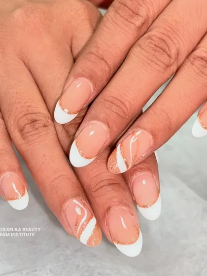 Proving that simple can be stunning. This is my take on the "clean girl" aesthetic, featuring a classic French manicure on almond nails with a delicate swirl of rose gold glitter for a subtle pop.