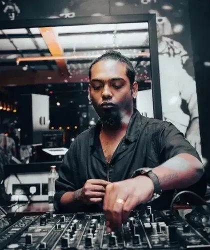 Let the music do the talking. A focused shot of me at the mixer, crafting the sound for the night.