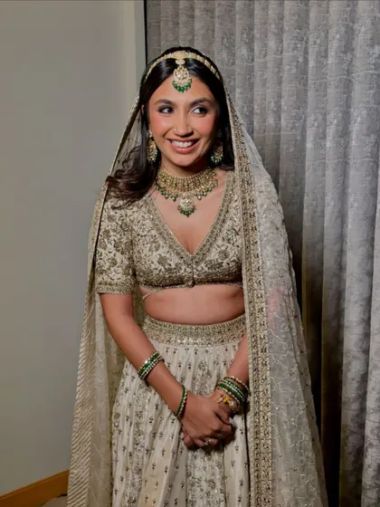 Another shot of the bride, looking happy and serene. The soft makeup and open hairstyle create a look of effortless elegance.