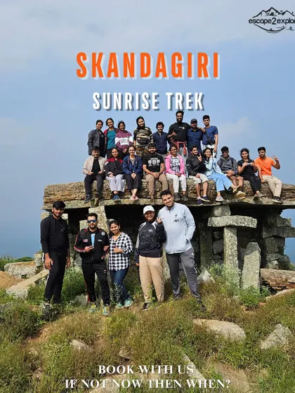 A promotional image for our Skandagiri Sunrise Trek, showing a group at the iconic stone structure on the peak.