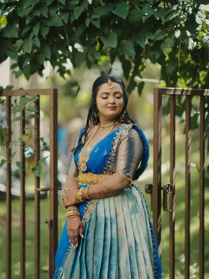 A stunning engagement look for a doctor couple in Mysore. The bride wore a beautiful blue half-saree, and we created a soft, glowing makeup look to complement it.