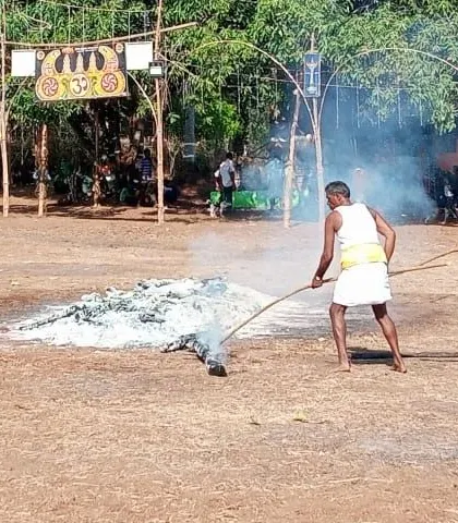 A Soliga tribesman tending to the embers after the fire walking ritual. The entire community participates in these events with incredible discipline.
