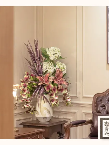 A wider view of the stunning lily and hydrangea arrangement, showing how it complements the rich, classic furniture and creates a sophisticated vignette.