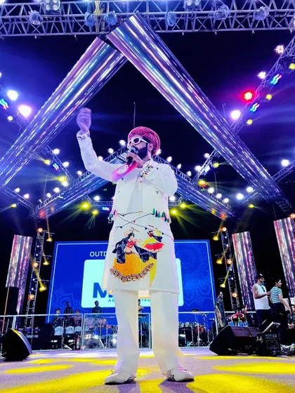 Under the bright lights of the Navratri stage, commanding the attention of the massive audience. My custom-painted kurta adds to the festive performance.