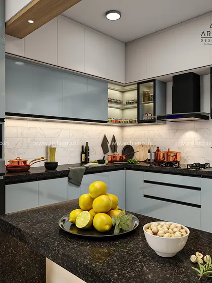 This contemporary modular kitchen blends style and efficiency. The design features light blue cabinets, a black granite countertop, and a breakfast island for casual meals.