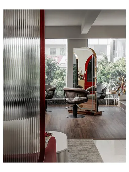 This image is a duplicate of ID 26 and shows the same fluted glass partition. It provides a sense of privacy for the styling stations while contributing to the salon's overall Art Deco-inspired aesthetic.
