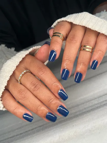 The full view of the stunning navy blue manicure. The high-gloss finish makes the color look rich and luxurious.