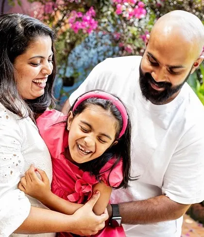 A big family hug full of laughter and joy. This photo perfectly captures the fun and energetic spirit of this family during their outdoor photoshoot. Real emotions always make the best pictures.