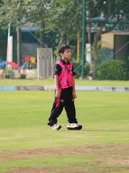 A young player walks on the field, focused and ready for his U-10 match.
