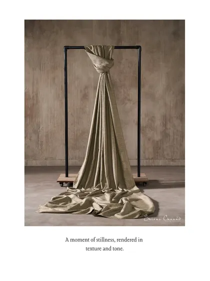 A moment of stillness, rendered in texture and tone. A single piece of fabric is knotted and hung from a simple frame, showcasing its weight and drape in a sculptural, minimalist composition.