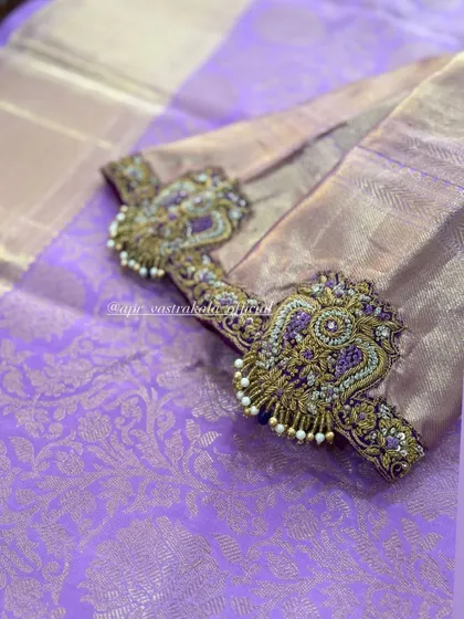 Heavily embroidered peacock motifs for sleeves.