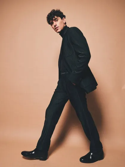 A full-length shot of a modern, patterned black suit. The clean lines and perfect fit demonstrate my focus on tailoring and creating a powerful silhouette.