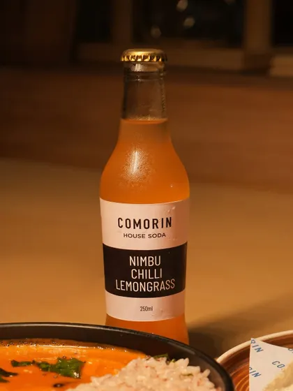 A close-up of our Nimbu Chilli Lemongrass house soda, a zesty and spicy beverage that perfectly complements our rich curries.