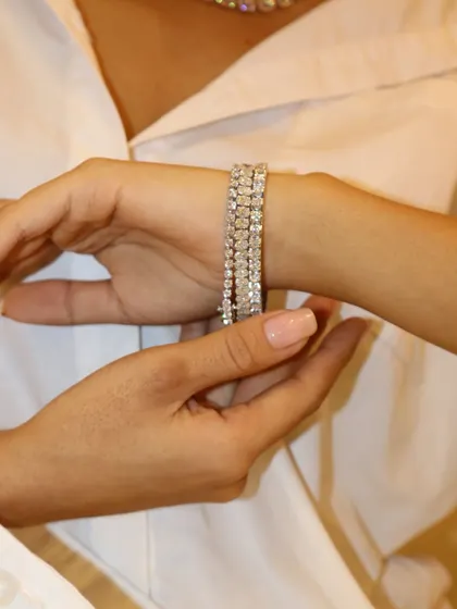 Your wrist, your spotlight. A stack of three diamond tennis bracelets creates an undeniable statement of luxury and elegance.