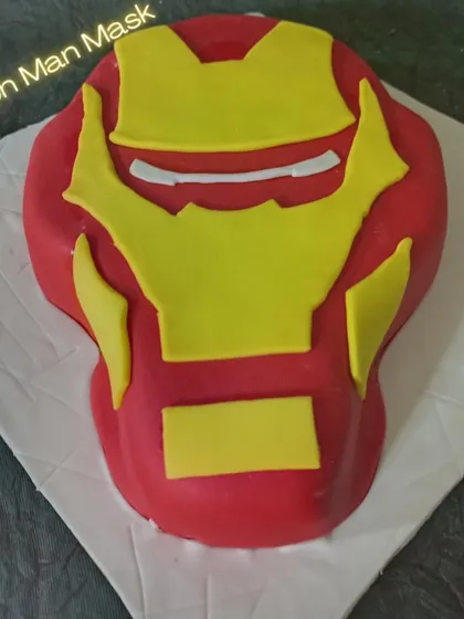 A 3D Iron Man mask cake that looks just like the real thing. This sculpted cake is a fantastic choice for any Marvel superhero fan.