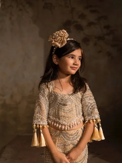 A closer look at the intricate beadwork and tassel details on the sleeves of our golden mermaid lehenga.
