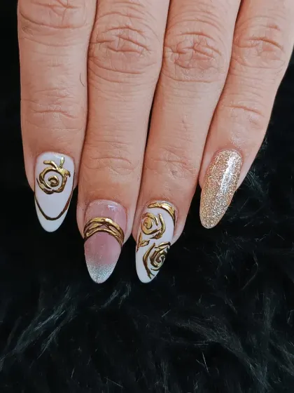 An elegant combination of a sheer white base with bold, sculpted gold metallic rose designs and a full gold glitter accent nail.