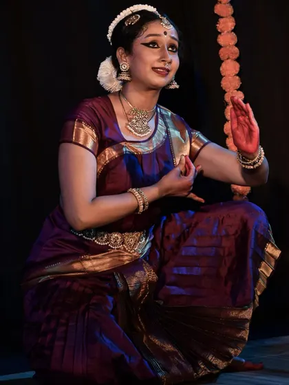 A close up of the dancer's expressive face and hands.