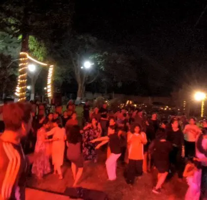 The crowd is fully engaged, dancing together.