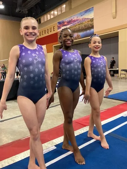 Three of our Level 7 gymnasts ready to compete at the multi-state regional championships.