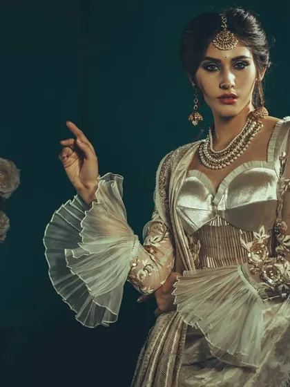 This image showcases a modern take on the classic saree, shot with a moody, cinematic lighting setup. The goal was to create an artistic and elegant portrait that highlights the unique design of the blouse and the intricate details of the fabric.